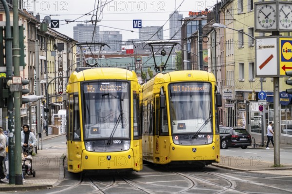 Ruhrbahn tram, on Altendorfer Straße, intersection Helenenstraße, in Essen-Altendorf, rush hour, traffic, skyline of the city centre of Essen, North Rhine-Westphalia, Germany