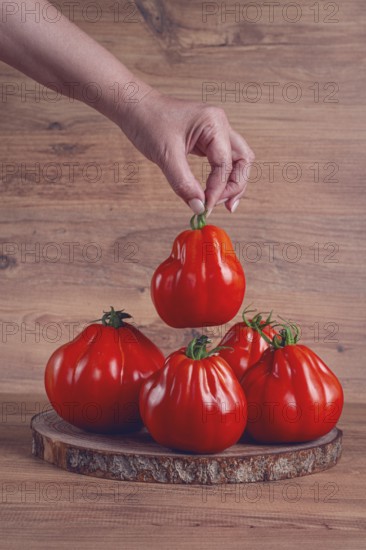 Khinkali tomatoes, on a wooden cutting board, wooden background, no people