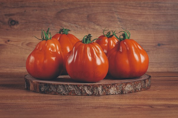Khinkali tomatoes, on a wooden cutting board, wooden background, no people