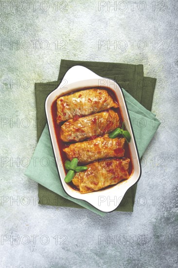 Stuffed cabbage rolls with minced meat, in tomato sauce, top view, without people, in the spotlight
