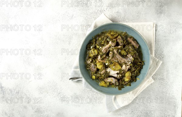 Chakapuli, Georgian dish, stewed meat with herbs and tkemali, in white wine, homemade, no people