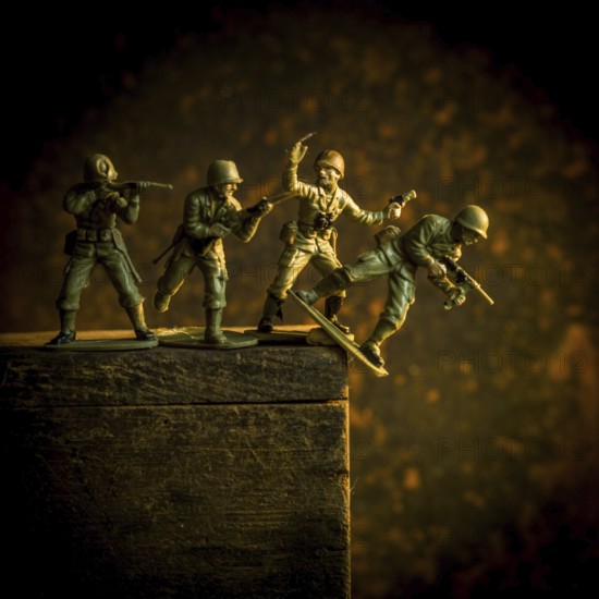 A group of toy soldiers are captured in motion as they navigate a steep incline, showcasing teamwork and strategy