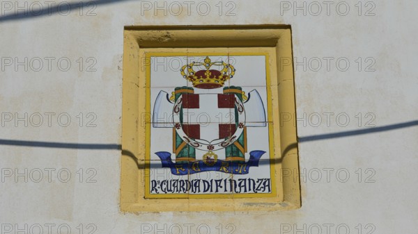 Guardia di Finanza, Coat of arms with crown and shield on beige background, textual elements, Armando Bernabiti, Historicism, Rationalism, Art Deco, Rationalism, Rodolfo Petraco, Fascism, Portolago, Lakki, Leros, Dodecanese, Greek Islands, Greece