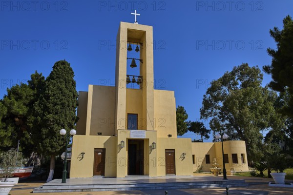Church of Saint Francis, Church of Saint Nicholas, Agios Nikolaos, Yellow church with bells and cross surrounded by natural greenery, Armando Bernabiti, Historicism, Rationalism, Art Deco, Rationalism, Rodolfo Petraco, Fascism, Portolago, Lakki, Leros, Dodecanese, Greek Islands, Greece
