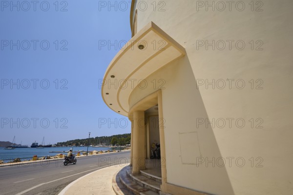 Theatre, Cinema, Round building side with arched architecture and view of street and sea, Armando Bernabiti, Historicism, Rationalism, Art Deco, Rationalism, Rodolfo Petraco, Fascism, Portolago, Lakki, Leros, Dodecanese, Greek Islands, Greece