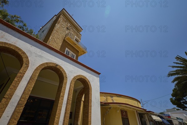 Market hall, Agora, Clock tower in clear style with arches and yellow elements, impresses in the sunlight, Armando Bernabiti, Historicism, Rationalism, Art Deco, Rationalism, Rodolfo Petraco, Fascism, Portolago, Lakki, Leros, Dodecanese, Greek Islands, Greece