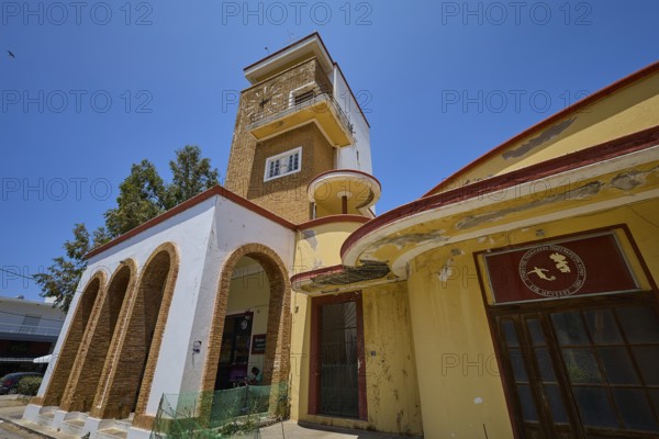 Covered market, agora, building with clock tower, characterised by red and yellow details, robust and steeped in history, Armando Bernabiti, historicism, rationalism, art deco, rationalism, Rodolfo Petraco, fascism, Portolago, Lakki, Leros, Dodecanese, Greek Islands, Greece