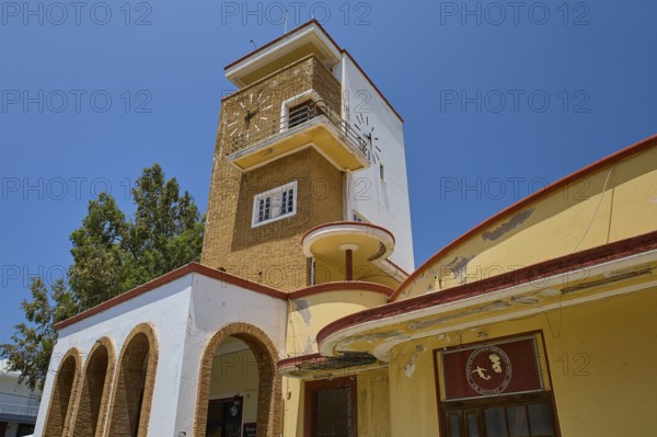 Market Hall, Agora, Historic Clock Tower with arches and surrounding trees under bright sunshine, Armando Bernabiti, Historicism, Rationalism, Art Deco, Rationalism, Rodolfo Petraco, Fascism, Portolago, Lakki, Leros, Dodecanese, Greek Islands, Greece