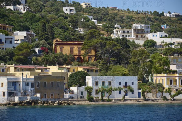 Colourful houses embedded in green vegetation on the coast, Lakki, Leros, Dodecanese, Greek Islands, Greece