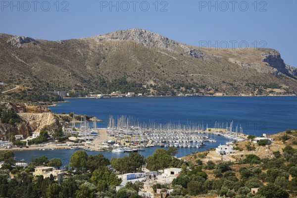 Panoramic view of a harbour full of sailing ships on a picturesque coastal landscape, Lakki, Leros, Dodecanese, Greek Islands, Greece