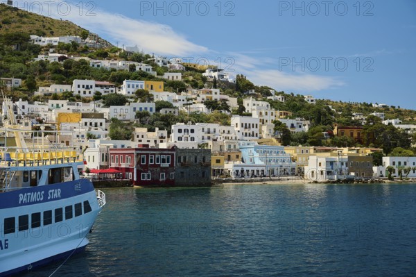 City view from a ship over the blue sea with hilly background landscape, Lakki, Leros, Dodecanese, Greek Islands, Greece
