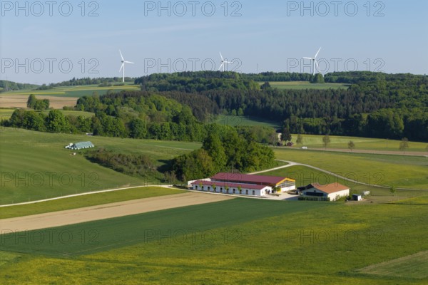 Idyllic rural scene with windmills, green fields and a farm under a blue sky, near Westerheim, Swabian Alb, Baden-Württemberg, Germany