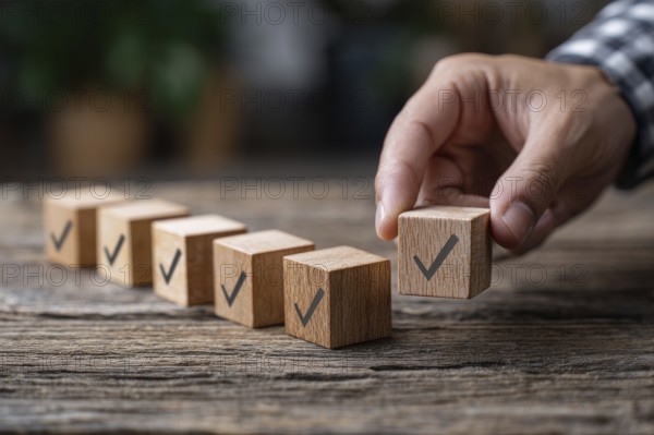 Checklist and task progress tracking concept. A hand placing the final checkmark on wooden blocks in a progress bar, AI generated