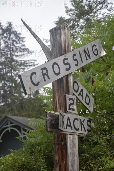 Clover Lick, West Virginia - An old railroad crossing sign stands next to the Greenbrier River Trail. The trail is on the railbed of the former Chesapeake and Ohio Railway. It runs 78 miles in eastern West Virginia and offers hiking, biking, and horseback riding