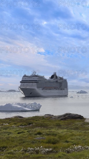 Iceberg seen from cruise ship vacation near Greenland coast in Arctic circle near Ilulissat Disko Bay