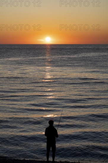 Angler fishing, silhouette, Étretat, sea, sunset, evening mood, atmospheric, Normandy, Seine-Maritime, France