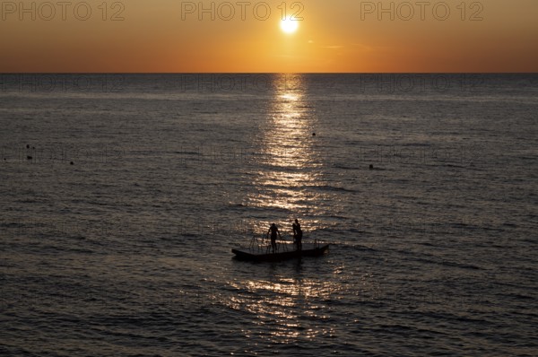 Children playing on bathing island, bathing raft, swimming island, Étretat, sea, sunset, evening mood, Normandy, Seine-Maritime, France