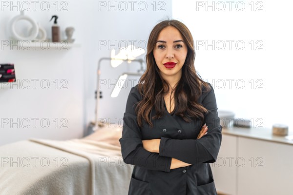 Confident female beautician standing with crossed arms in her modern beauty salon, representing professionalism and expertise in the beauty industry