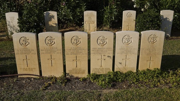 Rows of evenly spaced gravestones in the sunlight, surrounded by green vegetation, sinking of the H.M.S. Intrepid, military cemetery, Commonwealth War Cemetery, military cemetery, WW2, 1939-1945, 179 graves, Alinda, Leros, Dodecanese, Greek Islands, Greece