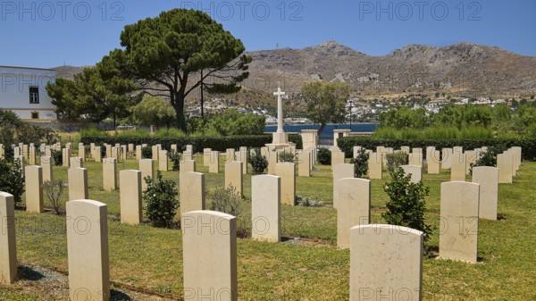 Cemetery with gravestones and view of mountains and sea, overgrown with trees, Military Cemetery, Commonwealth War Cemetery, Military Cemetery, WW2, 1939-1945, 179 graves, Alinda, Leros, Dodecanese, Greek Islands, Greece