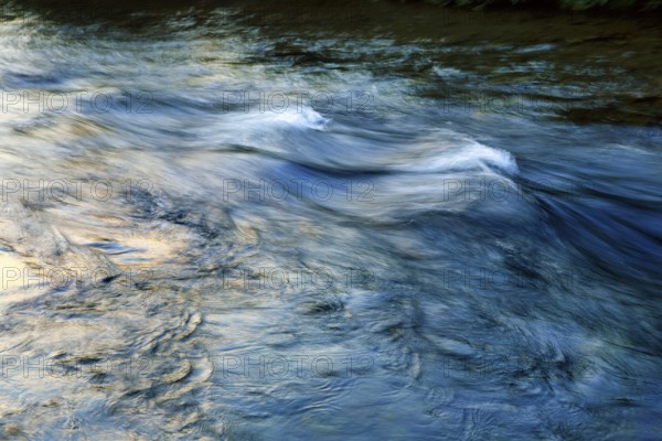 Waves in the river, river landscape, evening sun, motion blur, light reflections, Iceland