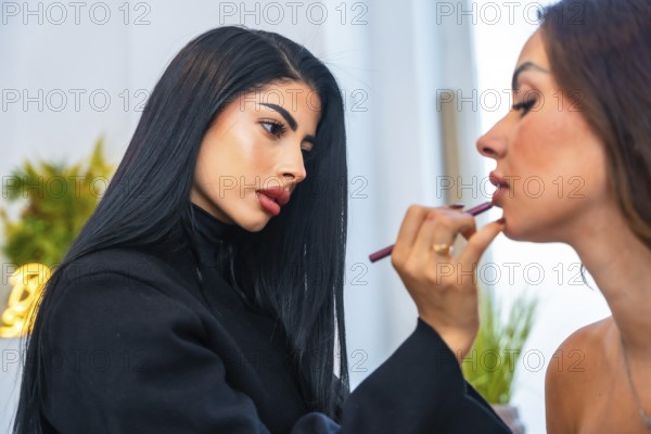 Makeup artist carefully applying lip liner on a client, enhancing her natural beauty in a professional salon environment