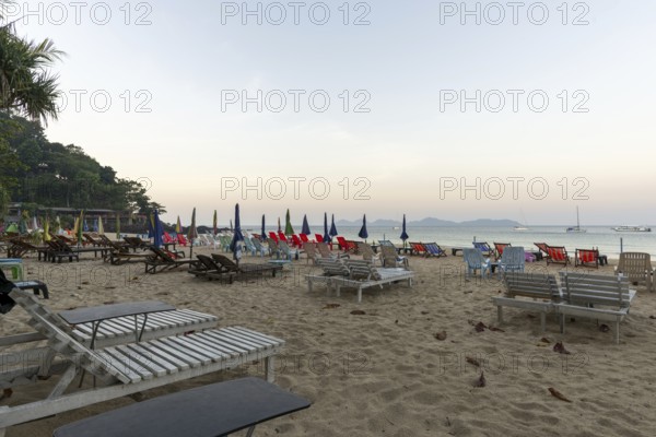 Abandoned deckchairs and parasol after sunset at Charlie Beach, Koh Mook Island, Andaman Sea, Thailand, Southeast Asia