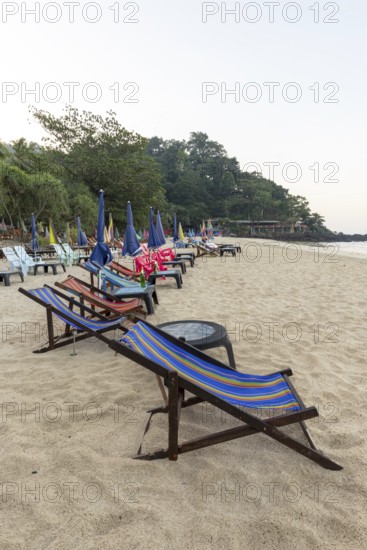 Abandoned deckchairs and parasol after sunset at Charlie Beach, Koh Mook Island, Andaman Sea, Thailand, Southeast Asia