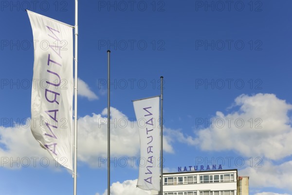 Naturana Miederfabriken, company building of Naturana Dölker Textilbekleidung, lettering, flags, Gomaringen, district of Tübingen, Baden-Württemberg, Germany