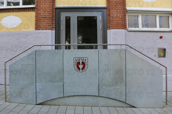 New town hall in the former Kindler corset factory, historical coat of arms of the Lords of Gomaringen, entrance, door, former Gotthold Kindler and Cie. corset factory, factory building, former textile industry, brick, building, Gomaringen, district of Tübingen, Baden-Württemberg, Germany