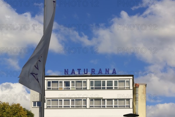Naturana Miederfabriken, company building of Naturana Dölker Textilbekleidung, lettering, flag, Gomaringen, district of Tübingen, Baden-Württemberg, Germany