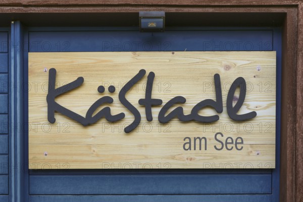 Wooden sign KäStadel am See, Kässtadel, specialist cheese shop with bistro, cheese shop, delicatessen, café, regional cuisine, small restaurant, refreshments, Oberuhldingen district, Uhldingen-Mühlhofen municipality, Lake Constance district, Baden-Württemberg, Germany