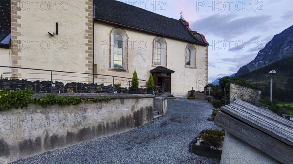 Late Gothic Catholic parish church of Saints George and Nicholas from around 1500 with churchyard, in Oetz im Ötztal, Tyrol, Austria, for editorial use only