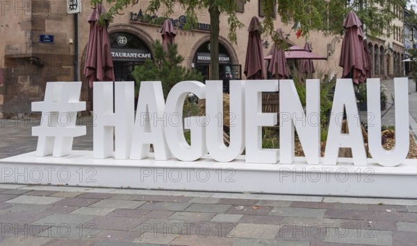 Large lettering in an urban setting with cafés in the background and autumnal flair, Haguenau, Bas-Rhin department, Alsace, France