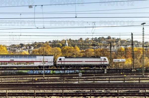 InterCity entering Stuttgart Central Station in autumn. Apron with station sign. Stuttgart, Baden-Württemberg, Germany