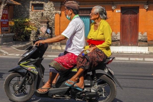 Motorcyclists wearing ceremonial clothes, Bali, Indonesia