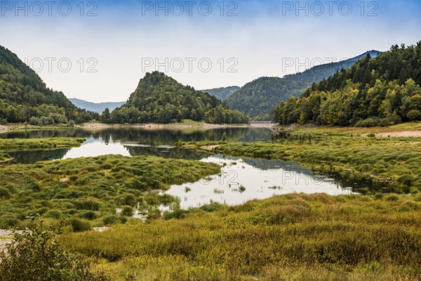 Picturesque mountain lake with water reflections in autumn, Lac de Kruth-Wildenstein, Kruth, Vosges, Alsace-Lorraine, Department of Vosges Haut-Rhin, France