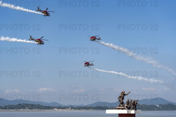 Indian Air Force (IAF) ALH Mk1 Sarang helicopters soar through the sky during an air show as part of the 93rd Air Force Day celebrations on November 8, 2025 in Guwahati, India