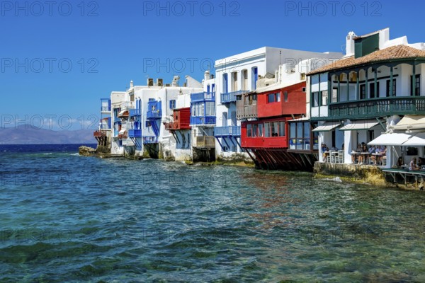 Mykonos, Cyclades, Greece - Little Venice is a picturesque neighborhood in Mykonos Town with colorful houses that stand right by the sea and are reminiscent of Venice. Little Venice is located on Alefkandra Bay next to the famous windmills of Mykonos. Mykonos is part of the Cyclades archipelago in the Aegean Sea