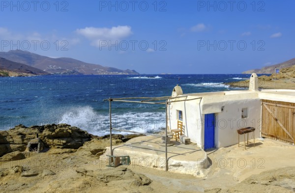 Mykonos, Cyclades, Greece - Ftelia Beach, fishing lodge on Ftelia beach, sandy beach on windy rocky coast in the north of the island