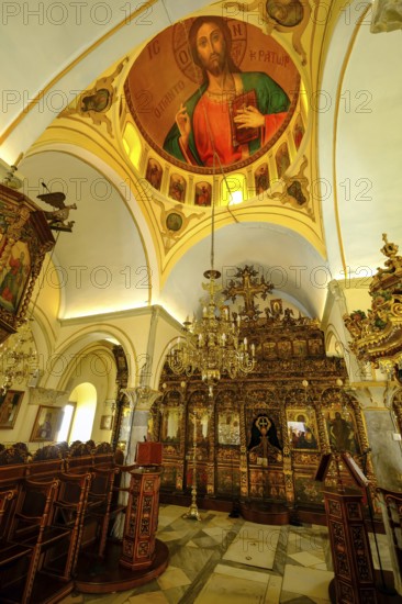 Ano Mera, Mykonos, Cyclades, Greece - The Panagia Tourliana monastery is the center of Ano Mera. Icons and lots of gold leaf inside the monastery. The men's convent from the 16th century on the village square in the interior of the island is now a tourist attraction much visited by tourists