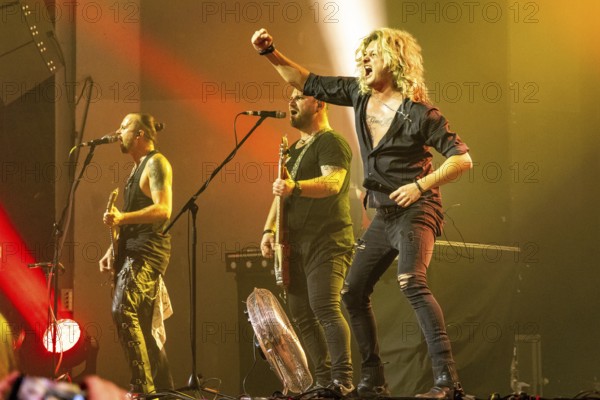 Ande Braun (guitarist), Steffen Haile (bassist) and Hannes Braun (singer) of the band Kissin' Dynamite live on Back with a Bang World Tour at Capitol Hannover on 09.11.2025