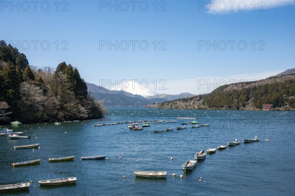 Attached rowing boats, view of Lake Ashi with Mount Fuji volcano, Hakone, Japan