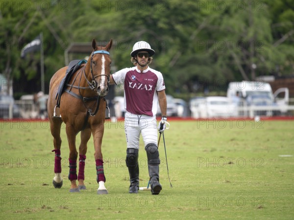 Polo player Nicolas Pieres from Team Zeta Kazak with his injured horse, the bleeding wound visible on the pallor, at the 132nd Open Argentine Polo Championship (Spanish Campeonato Argentino Abierto de Polo), Buenos Aires, Argentina