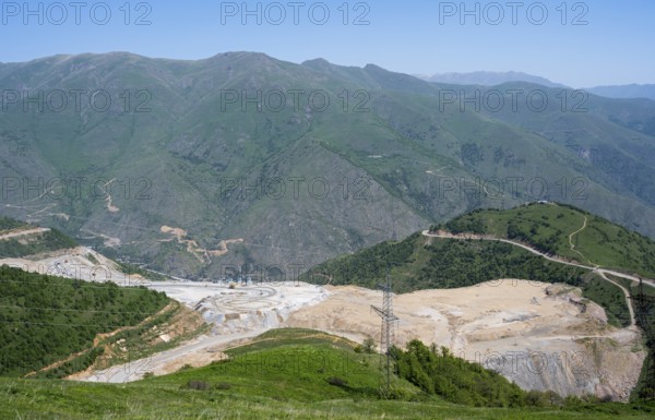 Industrial landscape with mining pit surrounded by green mountains, view of a quarry near Qajaran, Kajaran Qajaran, surrounded by the mountains of the Zangesur Range, Zangesur, Syunik province, Caucasus, Armenia