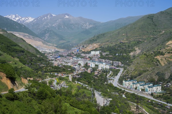 View of a city in a valley surrounded by mountains and green landscapes, view of Qajaran, Kajaran Qajaran, surrounded by the mountains of the Zangesur range, Zangesur, Syunik province, Caucasus, Armenia