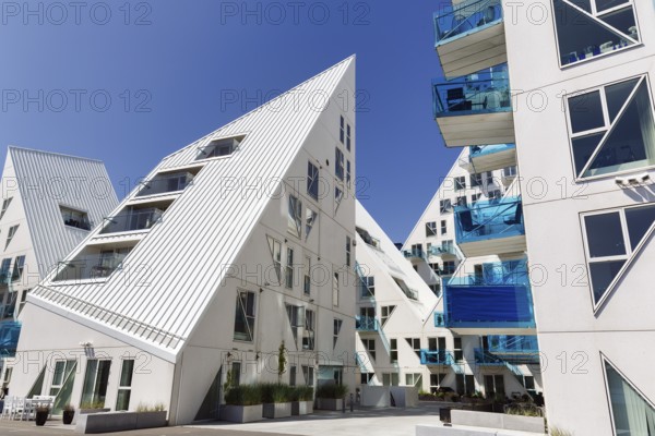 Distinctive white residential complex, turquoise balconies against blue sky, pyramid-shaped buildings, Isbjerget, iceberg, modern architecture in the harbor, Aarhus, Jutland, Denmark