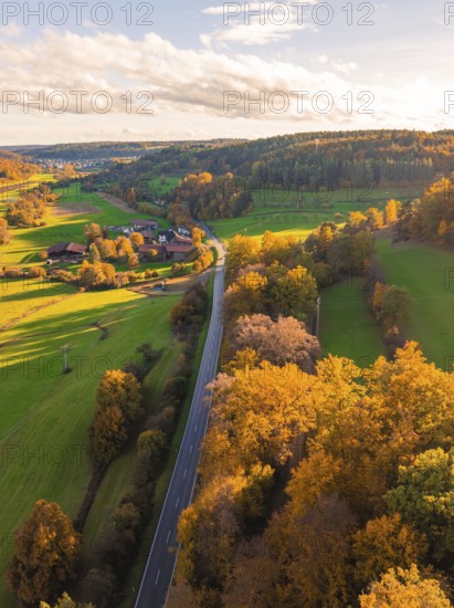 Road crosses autumnal forests and green fields at dusk, pure nature, Lehenweiler, Aidlingen, Böblingen district, Germany