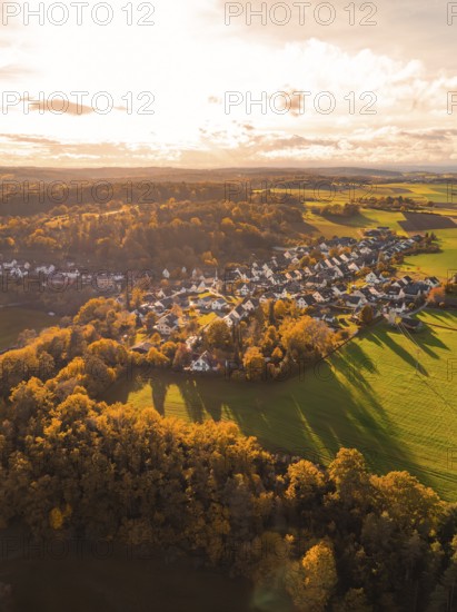 Autumn landscape with a village flooded with warm light, surrounded by fields and forests, Lehenweiler, Aidlingen, Böblingen district, Germany