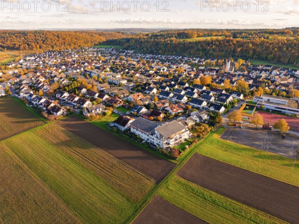 Large-scale view of a village bordering fields, in warm autumn light, Aidlingen, Böblingen district, Germany